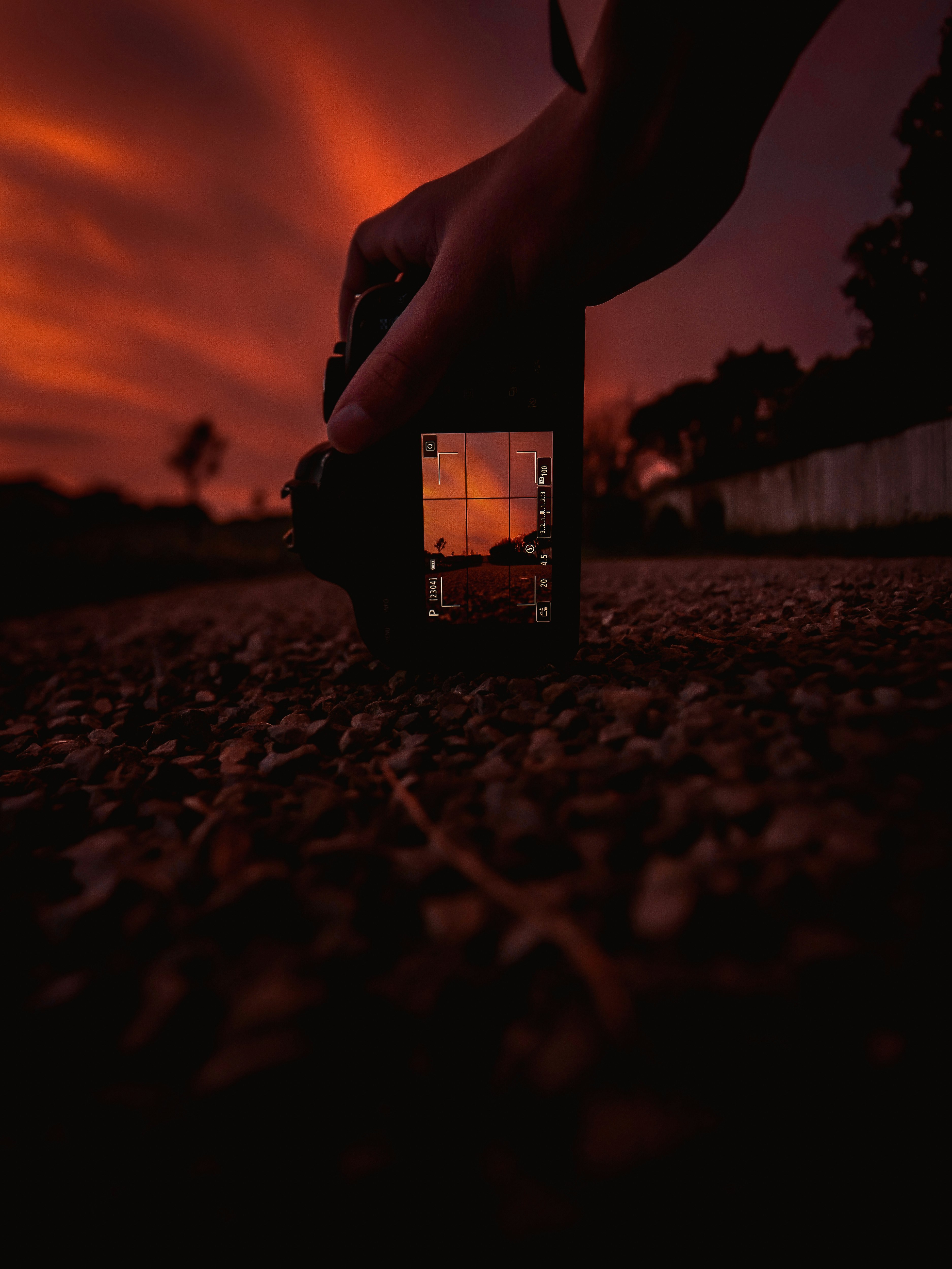 person holding black smartphone during sunset